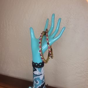 Gold bangles with pink gems